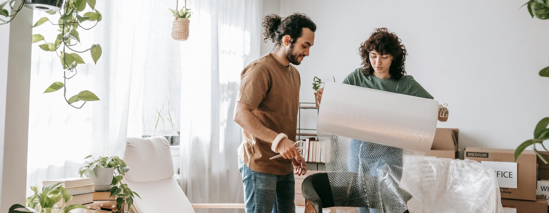 a man and woman unboxing items in a living room