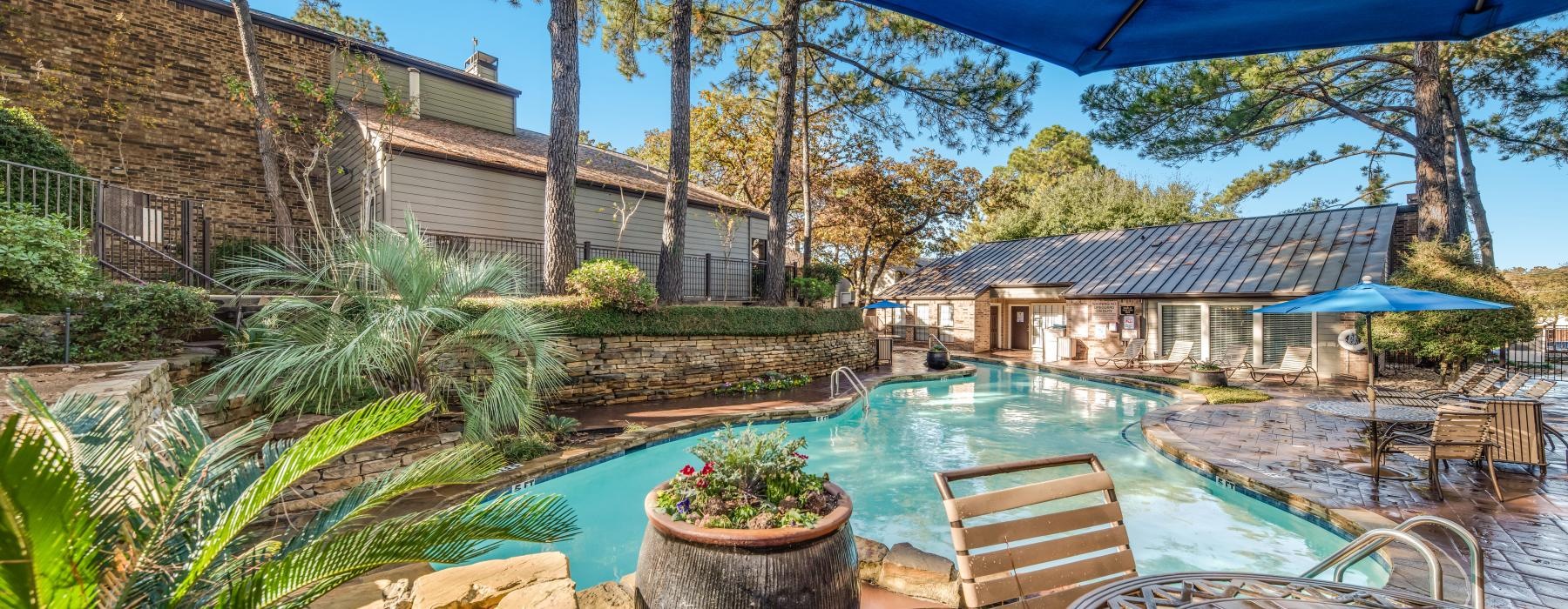 a pool with chairs and umbrellas
