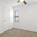 a room with a ceiling fan and a door