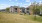 a large brick house with a lawn and trees in front of it