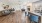 a large living room with a bar and a dining table
