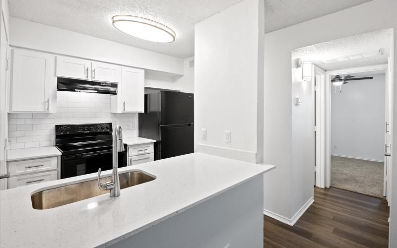 a kitchen with white cabinets