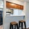 a kitchen with stools and a table