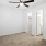 a room with a ceiling fan and a door